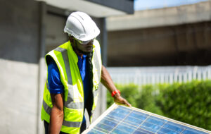 Technician checking on solar cell control panel.