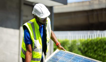 Technician checking on solar cell control panel.